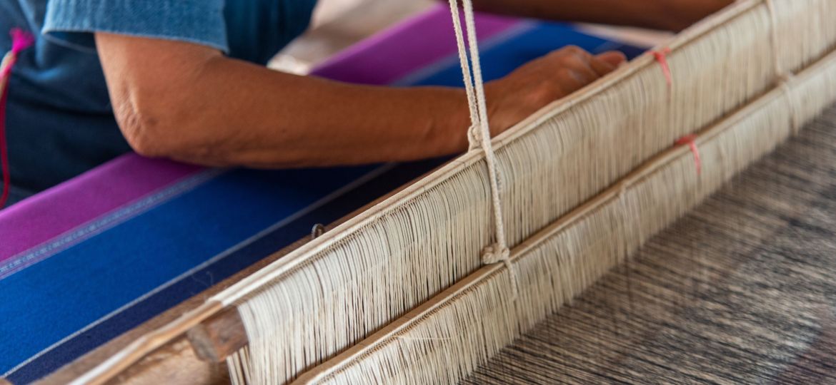 People are weaving with traditional Thai Lanna weaving machines